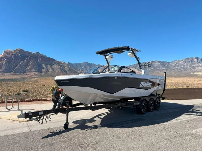 Slide: The Image of 2025 Malibu 25 LSV boat on trailer, desert mountain backdrop. - 5
