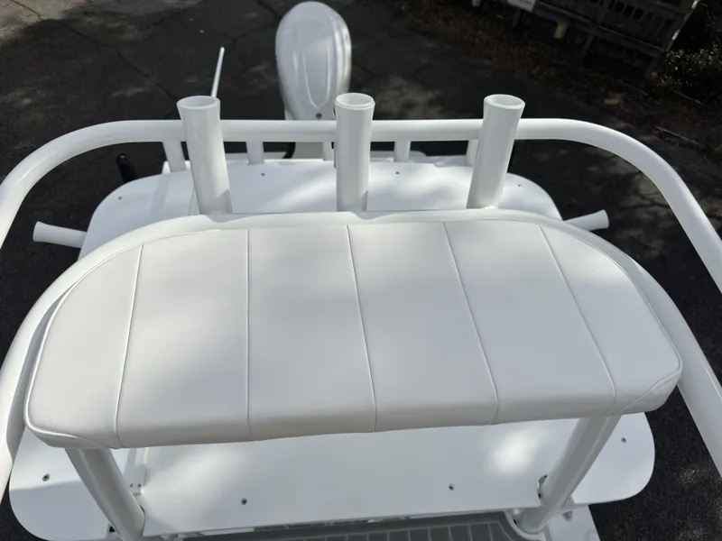 Slide: The Image of White cushioned seat on 2025 Pair Customs 24DV boat with rod holders. - 14
