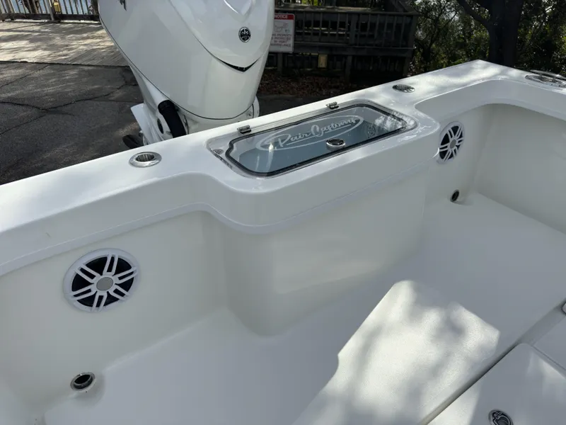 Slide: The Image of 2025 Pair Customs 24DV boat interior with speakers and storage compartment. - 20