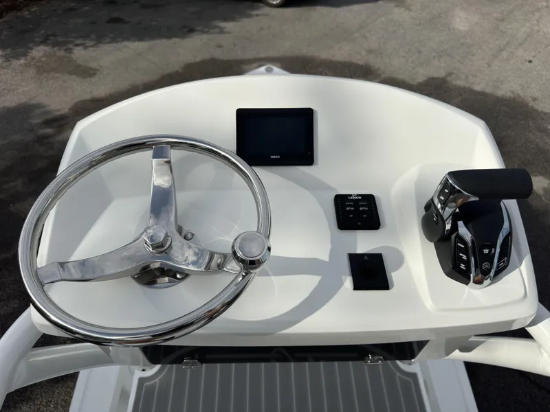 Slide: The Image of 2025 Pair Customs 24DV boat dashboard with steering wheel and controls. - 22