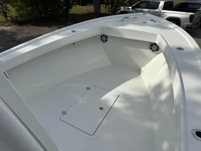 Slide: The Image of 2025 Pair Customs 24DV boat interior with spacious white deck and storage compartment. - 23