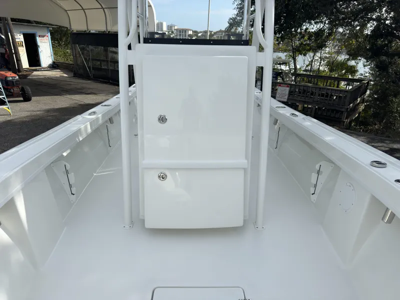 Slide: The Image of 2025 Pair Customs 24DV boat interior, featuring sleek white deck and storage compartments. - 10