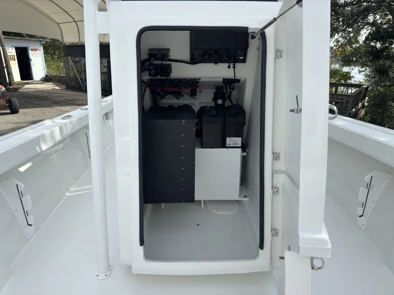 Slide: The Image of 2025 Pair Customs 24DV boat interior showing electrical components and storage area. - 11