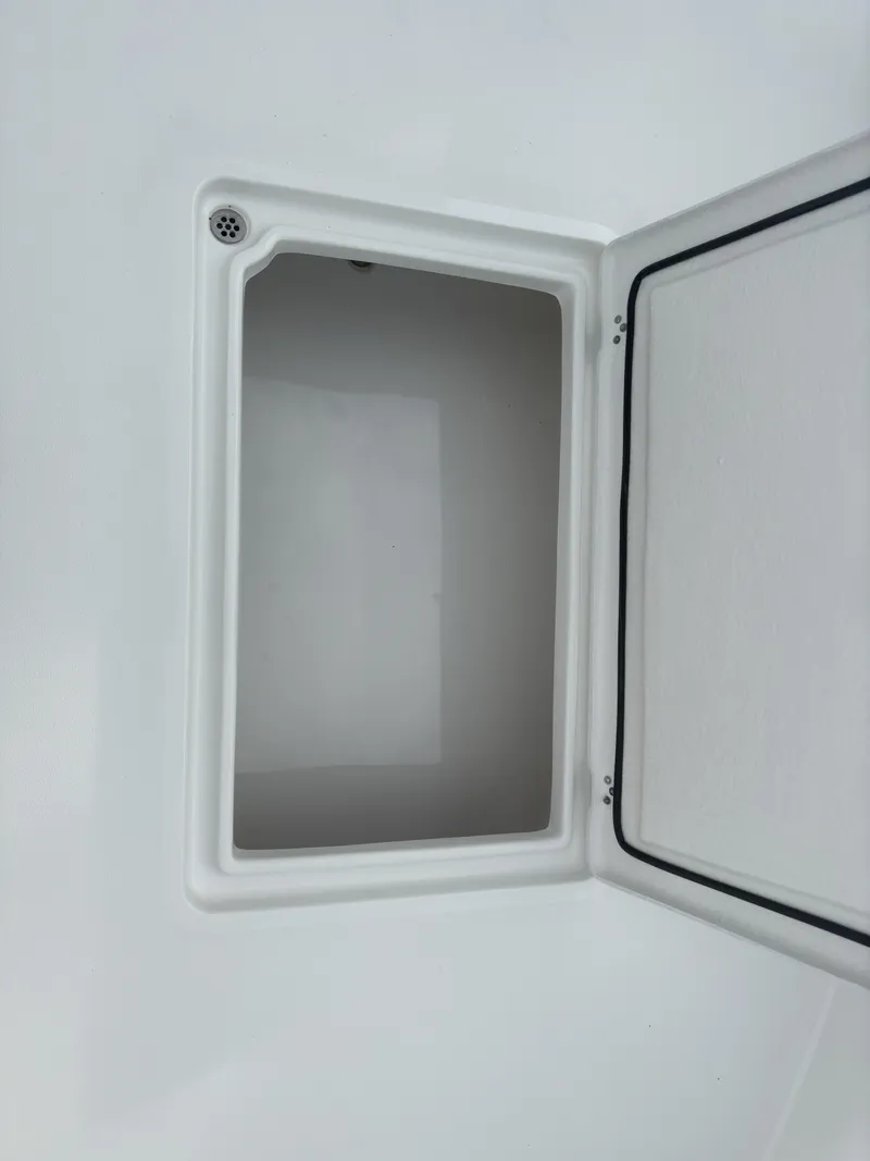 Slide: The Image of Open storage compartment on 2025 Pair Customs 24DV boat. - 12
