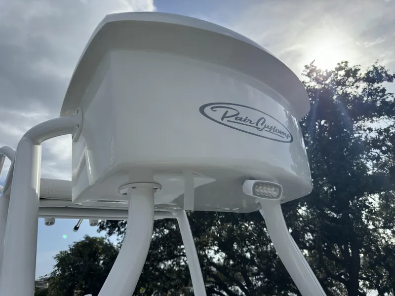 Slide: The Image of Pair Customs 24DV 2025 boat detail with logo, against a sunny sky backdrop. - 13