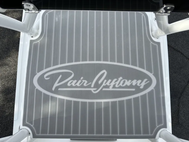 Slide: The Image of Pair Customs 24DV 2025 boat deck with logo, featuring sleek gray design. - 15