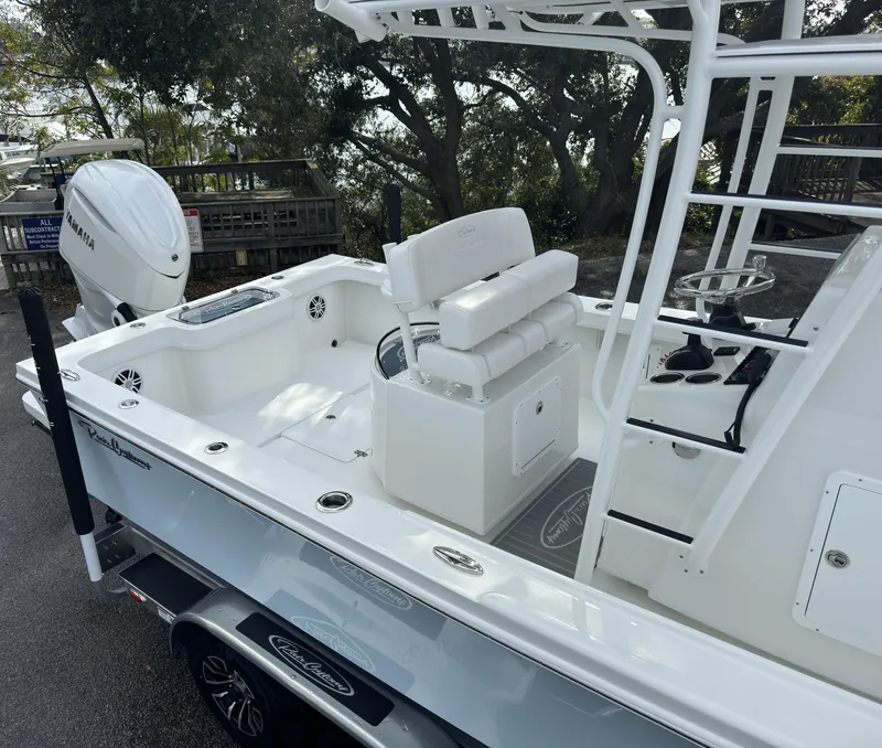 Slide: The Image of 2025 Pair Customs 24DV boat with Yamaha engine, white interior, and sleek design. - 16