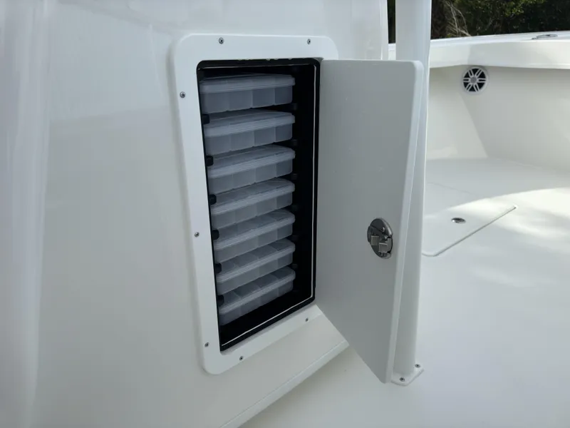 Slide: The Image of Open storage compartment on 2025 Pair Customs 24DV boat deck. - 8