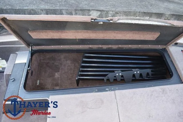 Slide: The Image of Open storage compartment in 2010 Skeeter ZX225 boat with rod holders. - 12