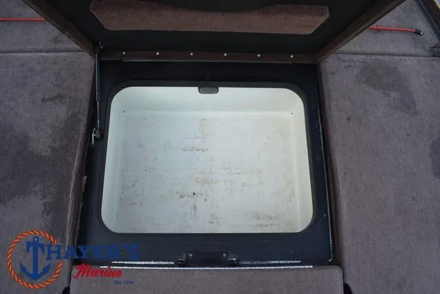 Slide: The Image of Open storage compartment on 2010 Skeeter ZX225 boat deck. - 13