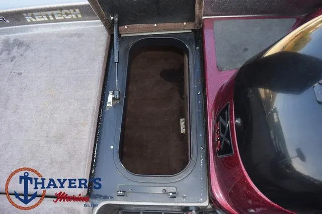 Slide: The Image of Open storage compartment on 2010 Skeeter ZX225 boat deck. - 16