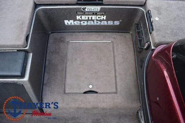 Slide: The Image of 2010 Skeeter ZX225 boat deck with storage compartment, featuring Keitech and Megabass branding. - 17