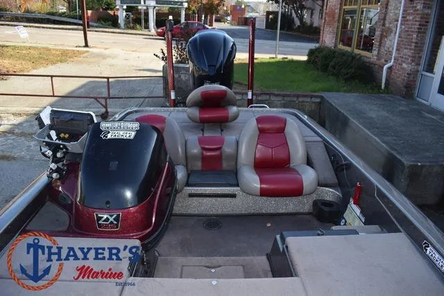 Slide: The Image of 2010 Skeeter ZX225 boat with red and gray seating, displayed at Thayer's Marine. - 19