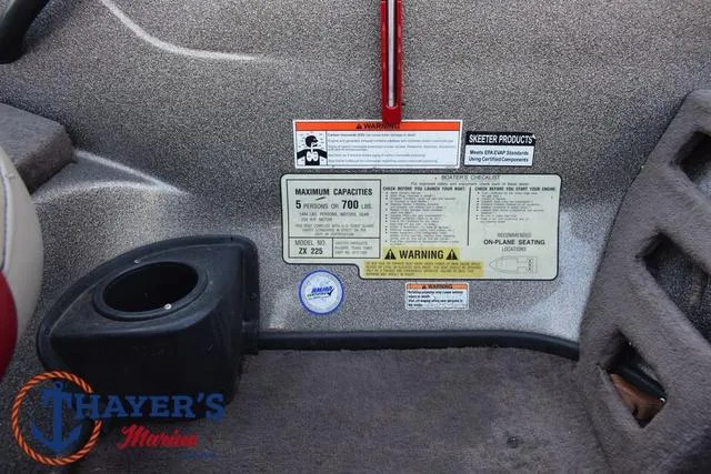 Slide: The Image of 2010 Skeeter ZX225 boat interior with capacity and safety warning labels. - 21