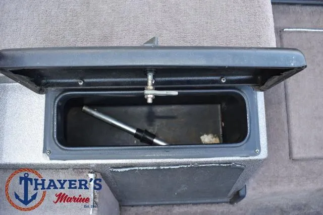 Slide: The Image of Open storage compartment in 2010 Skeeter ZX225 boat, featuring Thayer's Marine logo. - 23