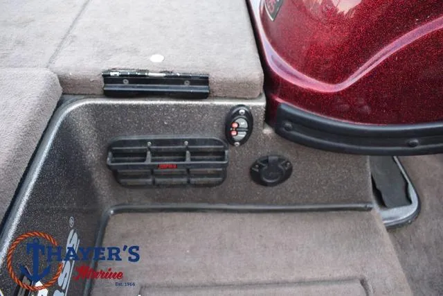 Slide: The Image of Interior view of a 2010 Skeeter ZX225 boat, featuring control panel and carpeted flooring. - 24
