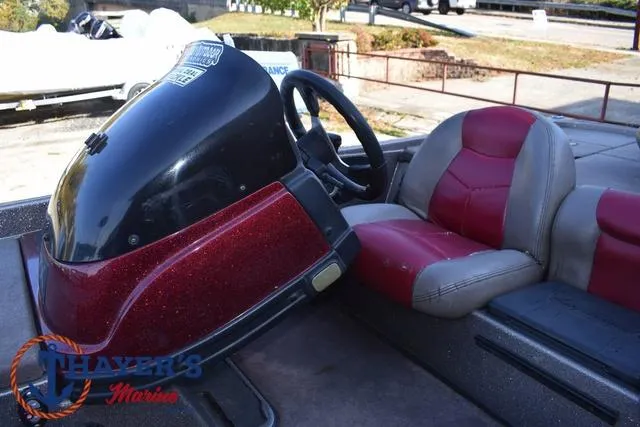 Slide: The Image of 2010 Skeeter ZX225 boat interior with red and gray seating, steering console. - 28