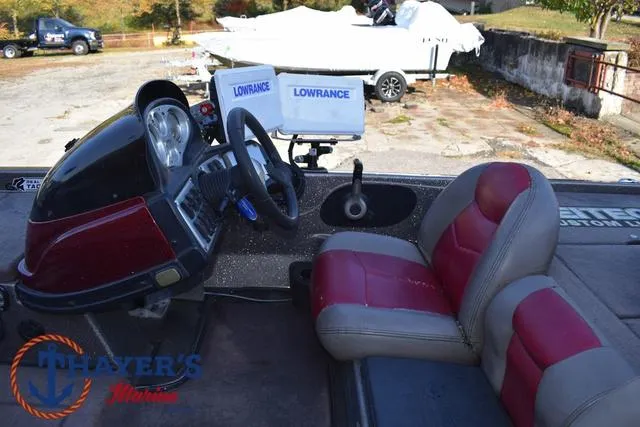 Slide: The Image of 2010 Skeeter ZX225 boat interior with red and gray seats, steering wheel, and Lowrance electronics. - 29