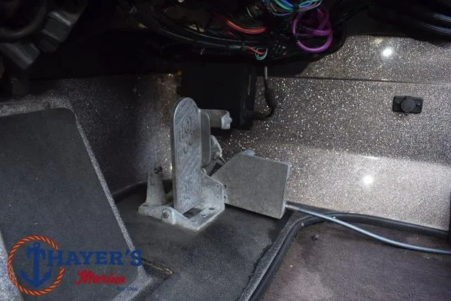 Slide: The Image of 2010 Skeeter ZX225 boat interior with foot pedal and wiring. - 32