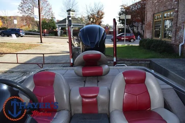 Slide: The Image of 2010 Skeeter ZX225 boat with red and gray seats, parked outdoors. - 33