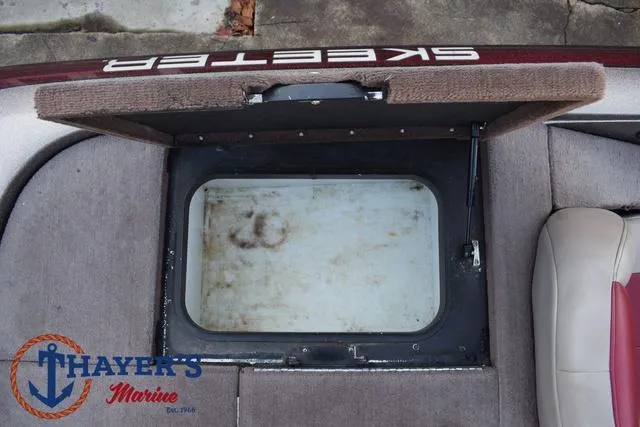Slide: The Image of Open storage compartment on 2010 Skeeter ZX225 boat, Thayer's Marine logo visible. - 35