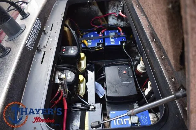 Slide: The Image of 2010 Skeeter ZX225 boat battery compartment with wiring and marine equipment. - 37