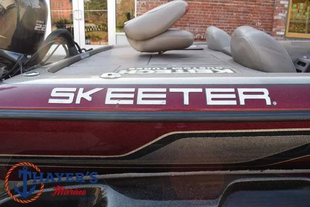 Slide: The Image of 2010 Skeeter ZX225 boat with maroon detailing, displayed at Thayer's Marine. - 4