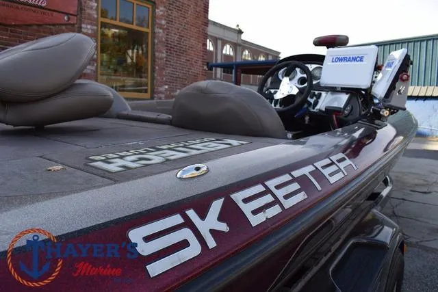 Slide: The Image of 2010 Skeeter ZX225 boat with Lowrance electronics, parked near a brick building. - 43