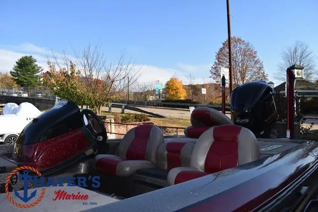 Slide: The Image of 2010 Skeeter ZX225 boat with red and gray seats, parked outdoors at Thayer's Marine. - 44