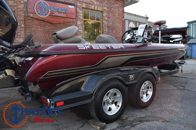 Slide: The Image of 2010 Skeeter ZX225 bass boat parked outside Thayer's Marine. - 46