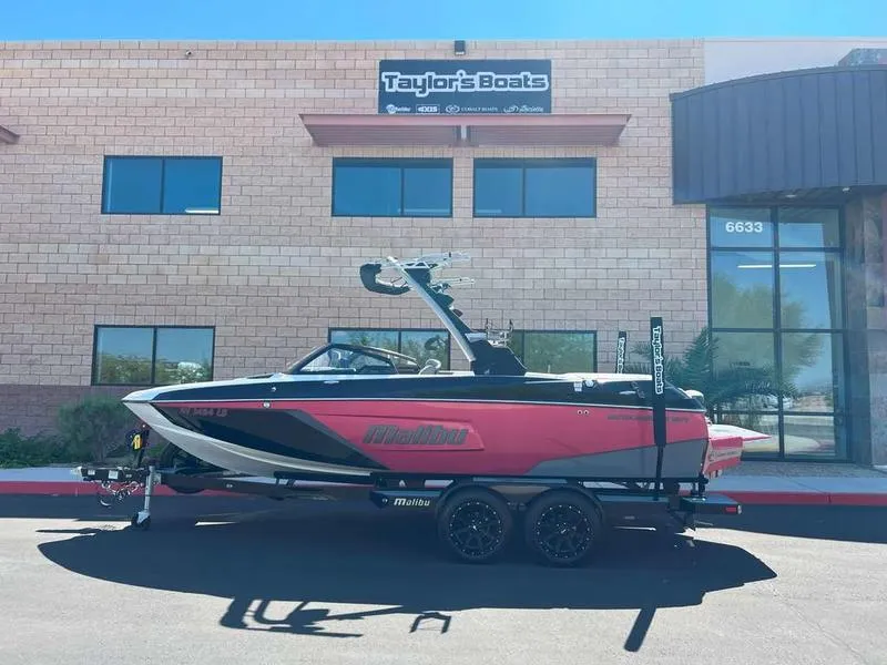 Slide: The Image of 2021 Malibu 22 LSV boat in front of Taylor's Boats dealership. - 0