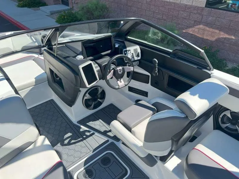 Slide: The Image of 2021 Malibu 22 LSV boat interior with modern dashboard and seating. - 14