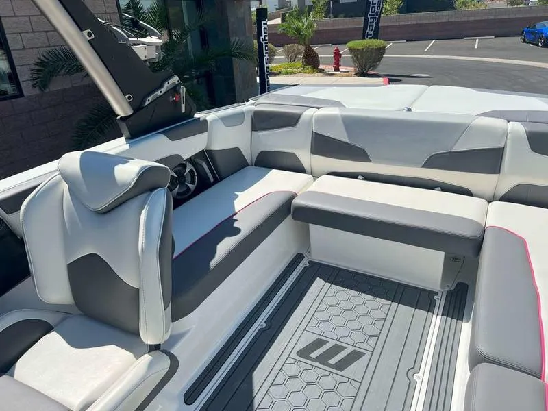 Slide: The Image of 2021 Malibu 22 LSV boat interior with modern seating and sleek design. - 15
