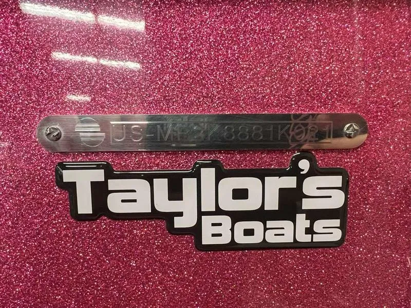 Slide: The Image of Pink Malibu 22 LSV 2021 boat with Taylor's Boats logo and serial number plate. - 3