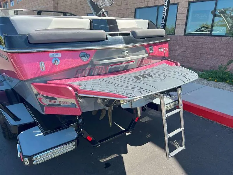 Slide: The Image of 2021 Malibu 22 LSV boat rear view with swim platform and ladder. - 4