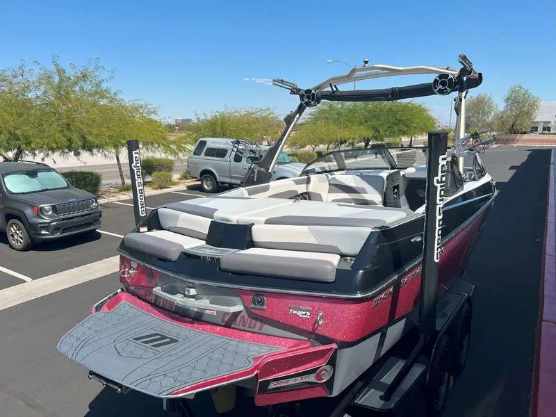 Slide: The Image of 2021 Malibu 22 LSV boat in parking lot, rear view, sunny day. - 8