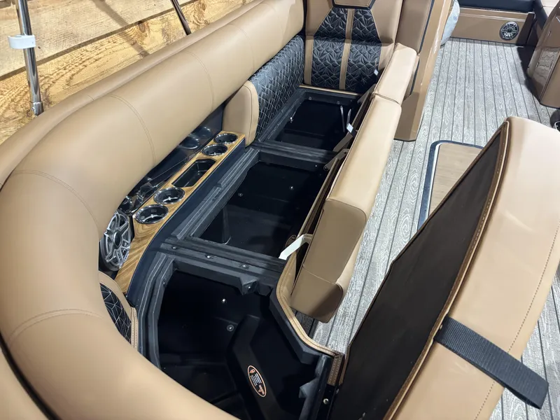 Slide: The Image of 2025 Harris Grand Mariner 250 SLEC interior with tan seating and storage compartments. - 10