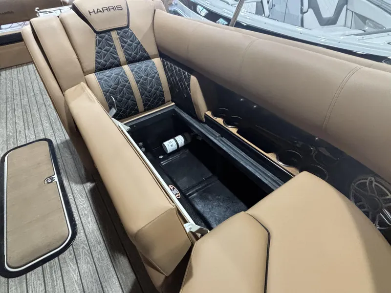 Slide: The Image of 2025 Harris Grand Mariner 250 SLEC interior with tan seating and storage compartment. - 12