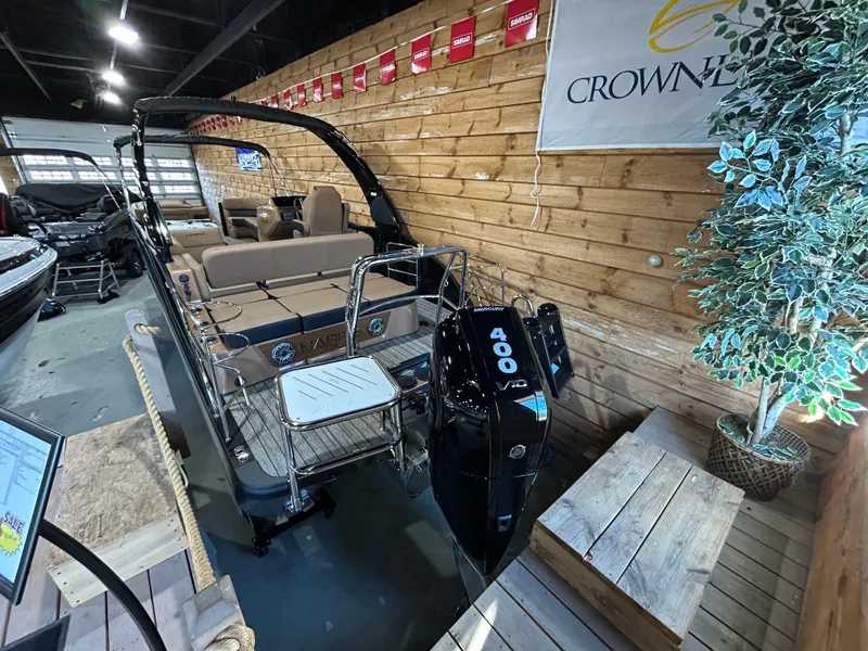 Slide: The Image of 2025 Harris Grand Mariner 250 SLEC boat in showroom, featuring powerful outboard motor. - 2