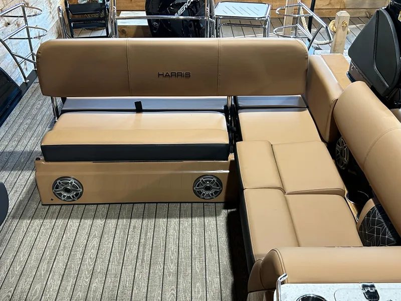 Slide: The Image of 2025 Harris Grand Mariner 250 SLEC boat interior with tan seating and built-in speakers. - 6