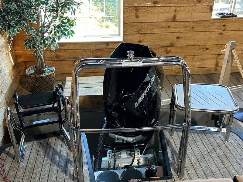 Slide: The Image of 2025 Harris Grand Mariner 250 SLEC boat interior with Mercury engine, wooden walls, and potted plant. - 8