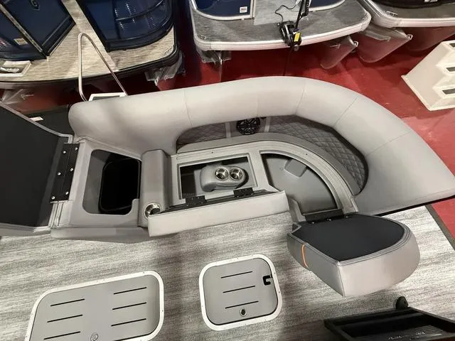 Slide: The Image of 2025 Bennington L Swingback 23 LSBA boat interior with gray seating and cup holders. - 10