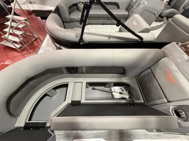 Slide: The Image of 2025 Bennington L Swingback 23 LSBA interior with gray seating and storage compartments. - 12