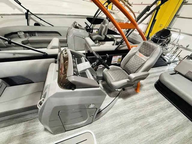 Slide: The Image of 2025 Bennington L Swingback 23 LSBA boat interior with modern helm and seating. - 14