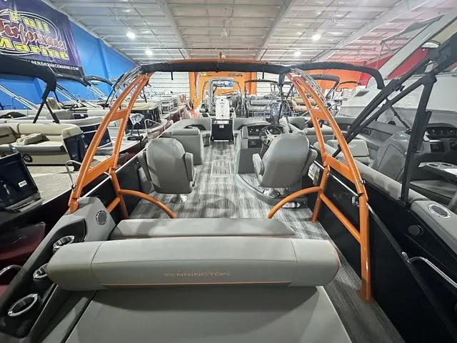 Slide: The Image of 2025 Bennington L Swingback 23 LSBA pontoon boat interior with modern seating and orange accents. - 23