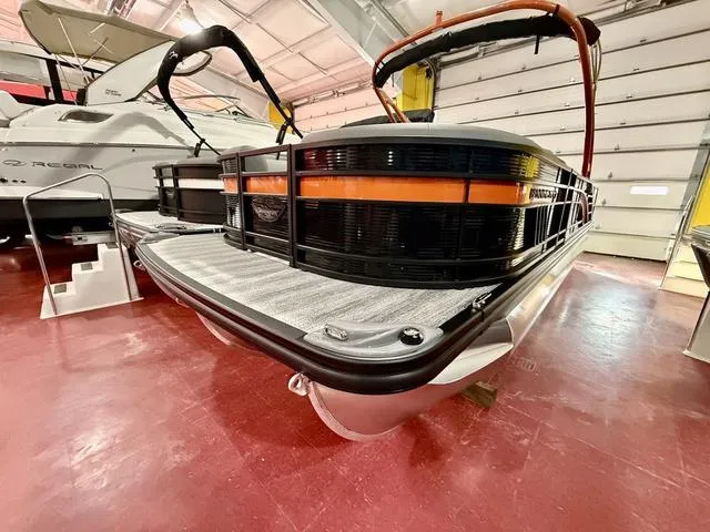 Slide: The Image of 2025 Bennington L Swingback 23 LSBA pontoon boat in showroom, featuring sleek design. - 5
