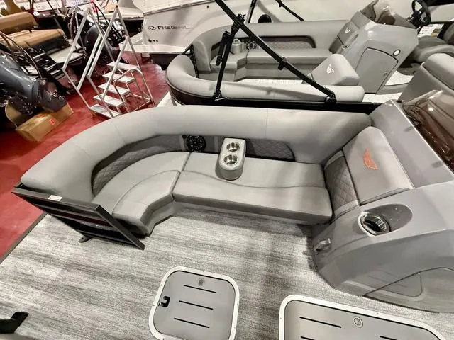 Slide: The Image of 2025 Bennington L Swingback 23 LSBA boat interior with gray seating and cup holders. - 9