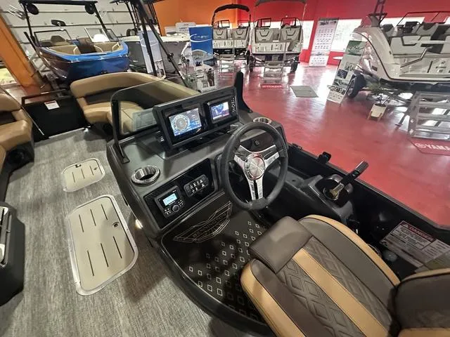 Slide: The Image of 2025 Bennington M Swingback 24 MSB interior with luxurious seating and modern dashboard. - 10