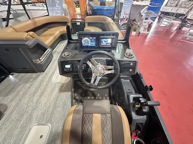 Slide: The Image of 2025 Bennington M Swingback 24 MSB boat interior with modern dashboard and seating. - 11