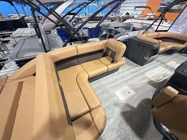 Slide: The Image of 2025 Bennington M Swingback 24 MSB boat interior with modern dashboard and seating. - 12